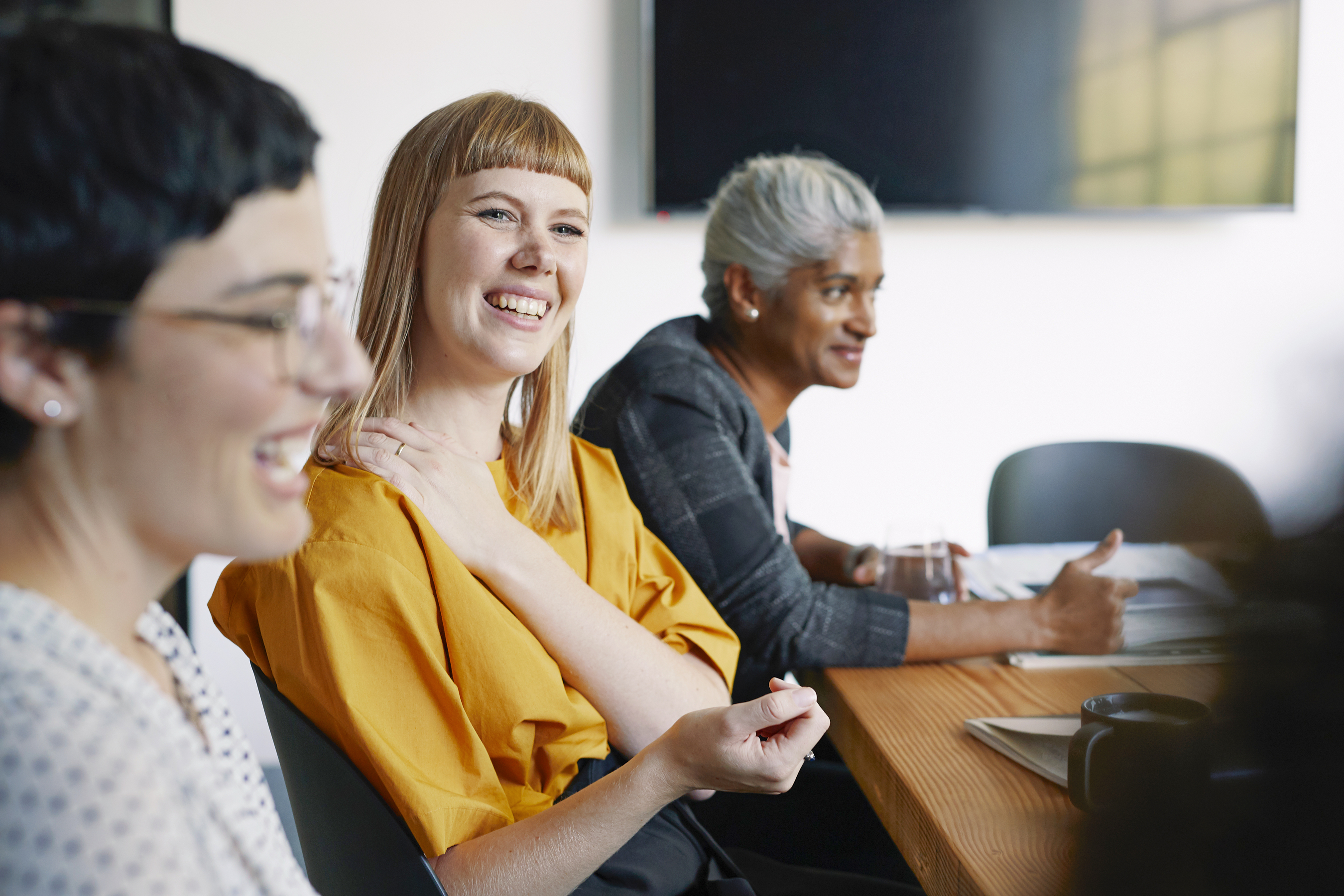 Women smiling during a conversation